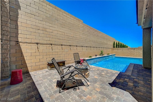 view of pool with a fenced in pool, a patio area, and a fenced backyard