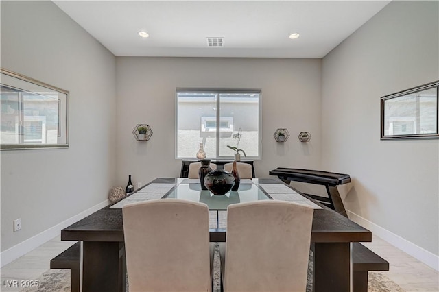 dining space featuring visible vents, baseboards, and wood finished floors