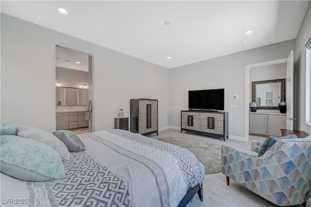 bedroom featuring light wood-style flooring, baseboards, connected bathroom, and recessed lighting