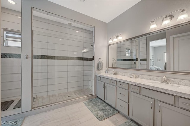 bathroom with double vanity, a sink, connected bathroom, and a shower stall