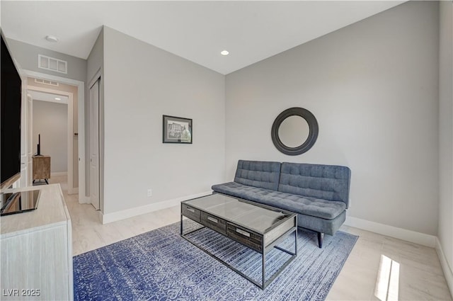 living area featuring recessed lighting, visible vents, and baseboards