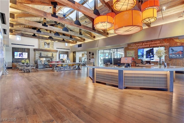 reception with a stone fireplace and a ceiling fan