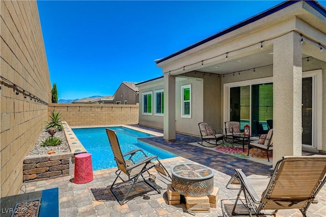 view of swimming pool featuring a patio, a fenced backyard, and a fenced in pool