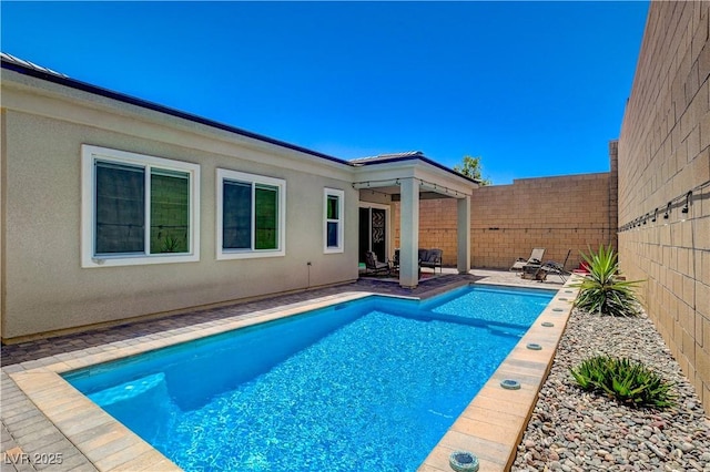 view of pool featuring a fenced in pool, a patio area, and a fenced backyard