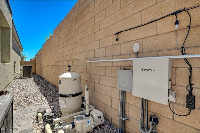 view of home's exterior featuring cooling unit and fence