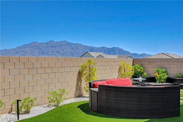 view of yard with a fenced backyard and a mountain view