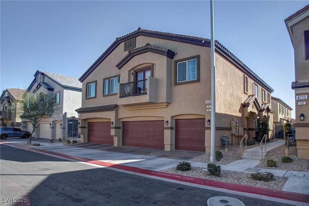 4705 Blaise Ave Unit 101, North Las Vegas, NV 89084 - view of front facade with a garage, a residential view, and stucco siding