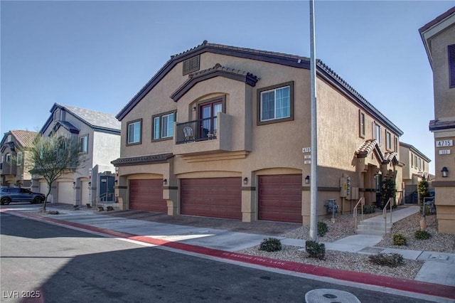 view of front facade with a garage, a residential view, and stucco siding