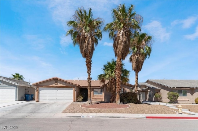 view of front of house with a garage, driveway, and stucco siding