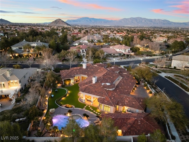 aerial view at dusk featuring a residential view and a mountain view