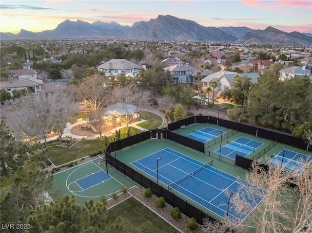 aerial view at dusk featuring a residential view and a mountain view