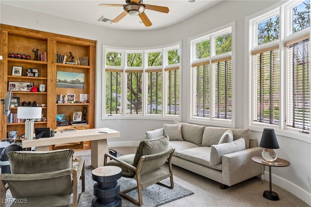 interior space featuring a ceiling fan, carpet, visible vents, and baseboards