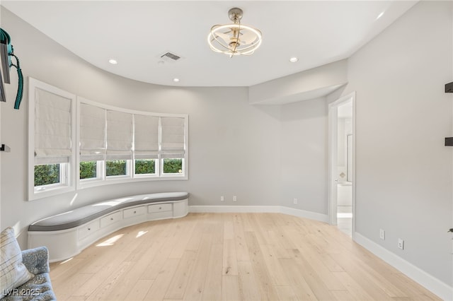 interior space with baseboards, visible vents, wood finished floors, and recessed lighting