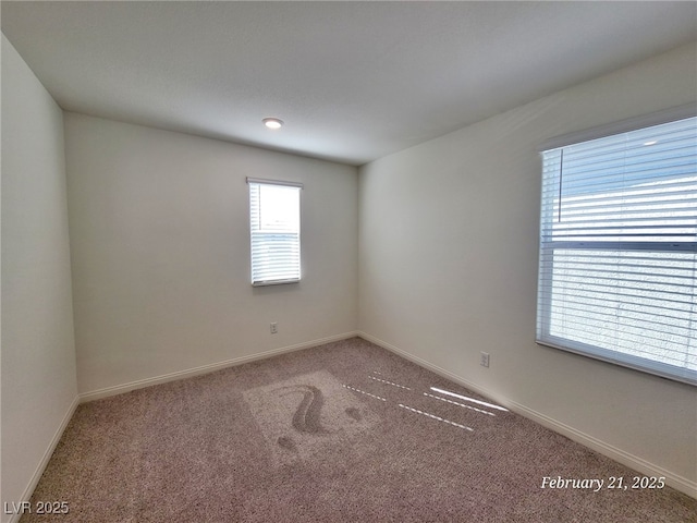 spare room with carpet flooring and baseboards