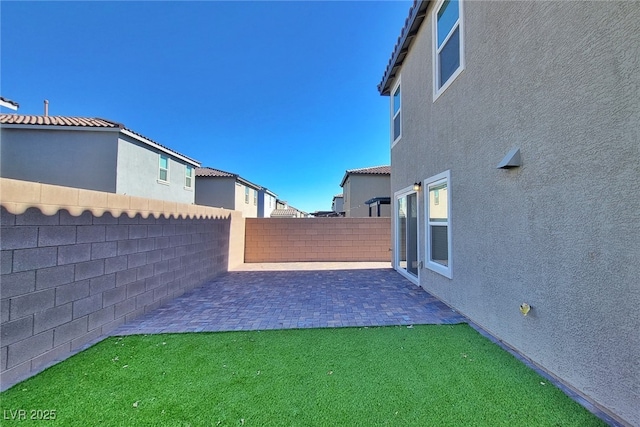 view of yard with a patio area and a fenced backyard