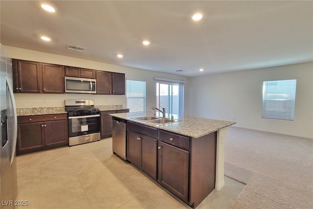 kitchen with a kitchen island with sink, recessed lighting, stainless steel appliances, a sink, and visible vents