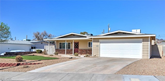 ranch-style house featuring concrete driveway, brick siding, and an attached garage