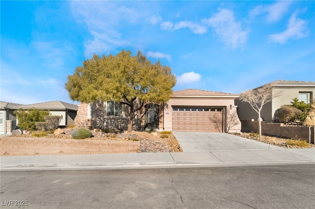 view of front of property featuring driveway, an attached garage, and stucco siding