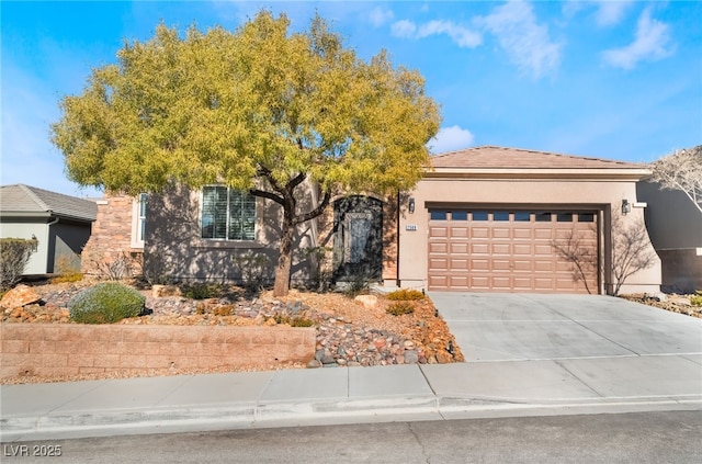 view of front of house with a garage, concrete driveway, and stucco siding