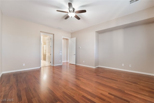 interior space with visible vents, ceiling fan, baseboards, and wood finished floors