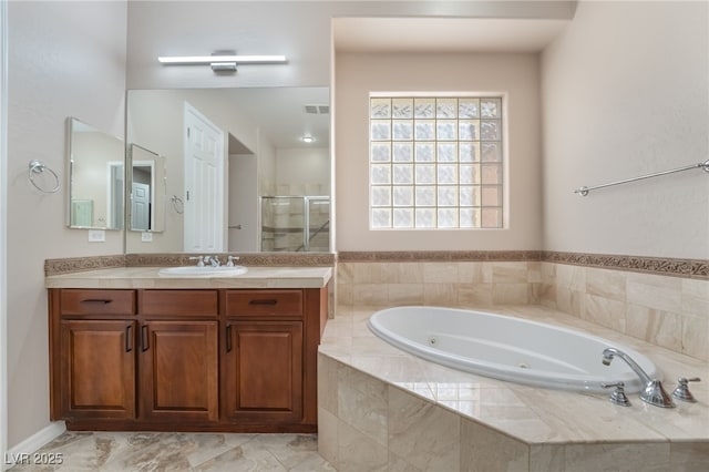 full bath with a stall shower, visible vents, a jetted tub, and vanity