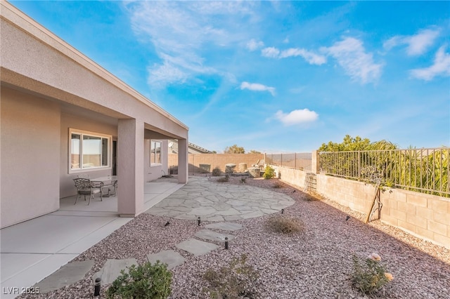 view of yard featuring a patio area and a fenced backyard