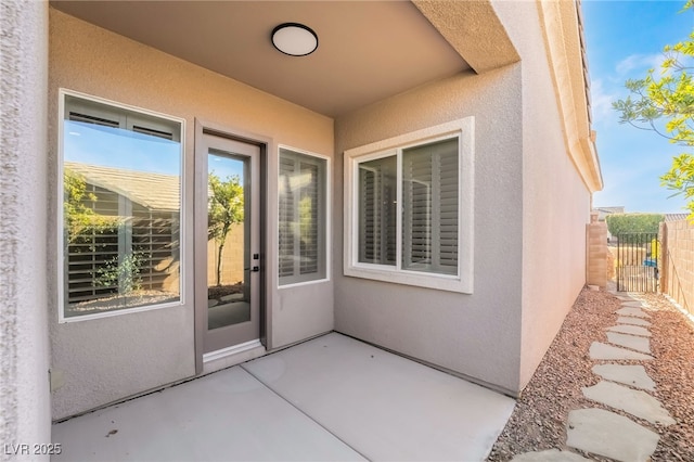 property entrance featuring a patio area and stucco siding