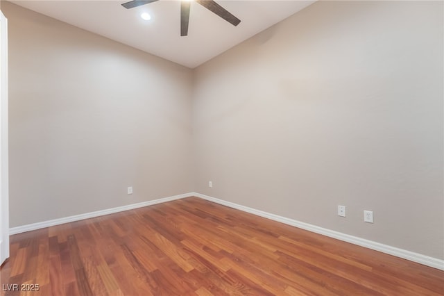 spare room with ceiling fan, recessed lighting, wood finished floors, baseboards, and vaulted ceiling