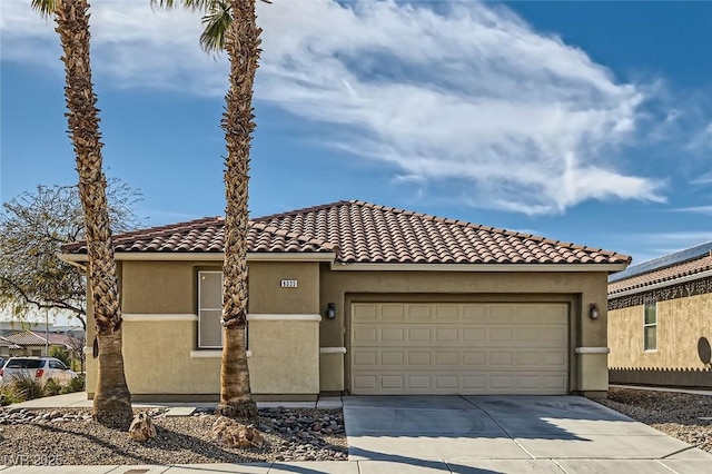 mediterranean / spanish-style house featuring a garage, driveway, a tiled roof, and stucco siding