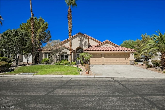 mediterranean / spanish home featuring a garage, concrete driveway, a tile roof, and stucco siding