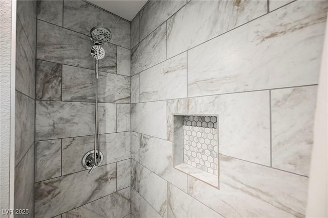 interior details featuring a tile shower