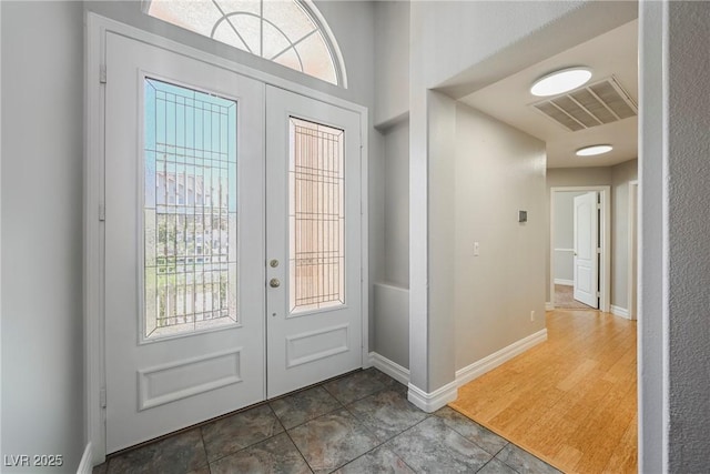 foyer featuring french doors, visible vents, and baseboards