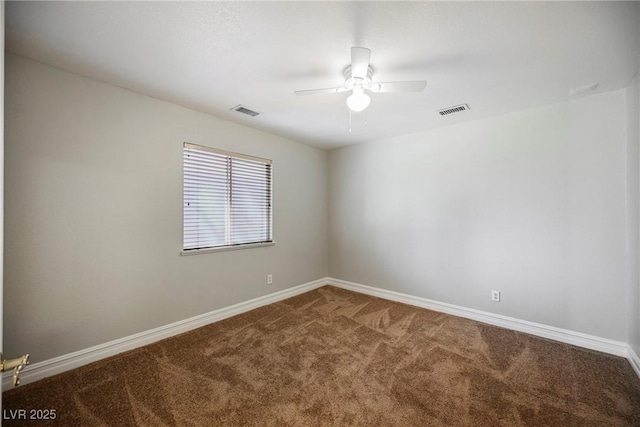 carpeted spare room with ceiling fan, visible vents, and baseboards