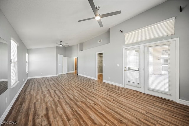 unfurnished living room with visible vents, baseboards, ceiling fan, wood finished floors, and high vaulted ceiling