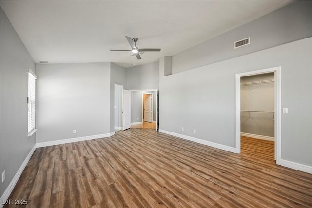 unfurnished bedroom with wood finished floors, visible vents, and baseboards