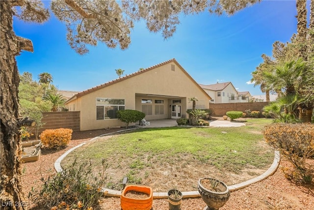 back of property featuring a patio area, a fenced backyard, a lawn, and stucco siding