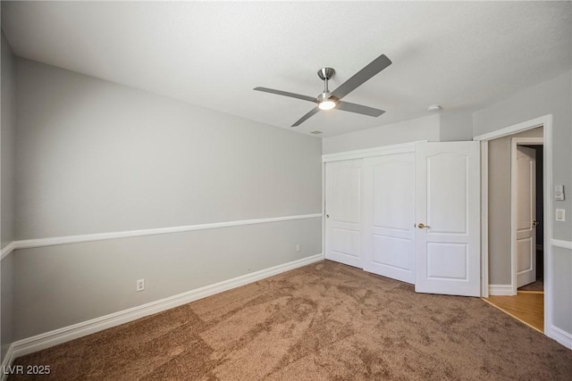 unfurnished bedroom featuring ceiling fan, a closet, carpet flooring, and baseboards