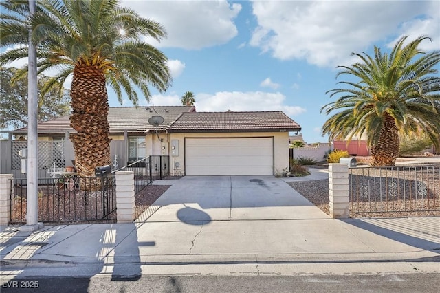 view of front of property with a garage, concrete driveway, a fenced front yard, and stucco siding