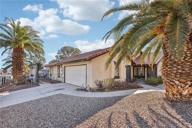 view of front of house with concrete driveway, fence, an attached garage, and stucco siding