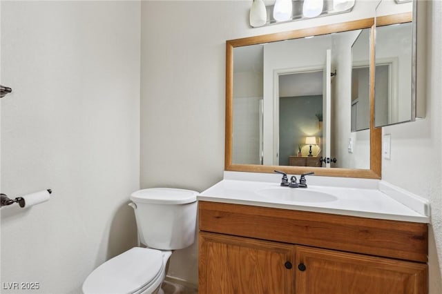 bathroom featuring toilet and vanity