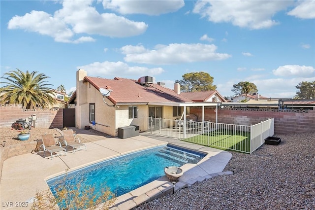 view of swimming pool featuring a patio, central AC unit, a fenced backyard, and a fenced in pool