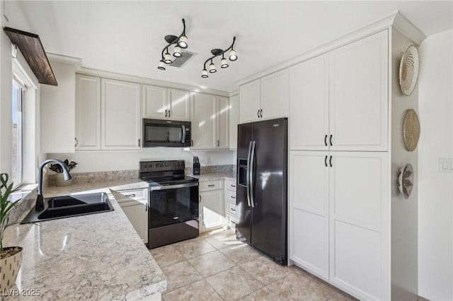 kitchen featuring a sink, electric range, white cabinetry, and black fridge