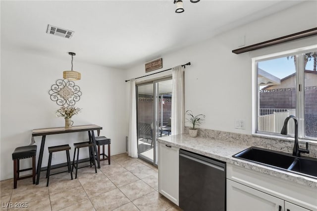 kitchen featuring a sink, white cabinetry, light countertops, dishwasher, and pendant lighting