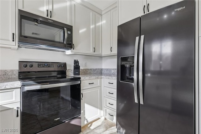 kitchen featuring light tile patterned floors, range with electric cooktop, white cabinets, light stone countertops, and fridge with ice dispenser