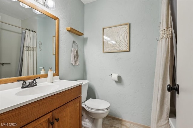 full bathroom with toilet, tile patterned flooring, vanity, and a textured wall