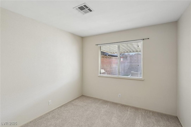 unfurnished room featuring visible vents and light colored carpet