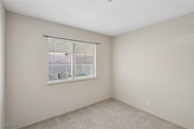 spare room featuring light colored carpet