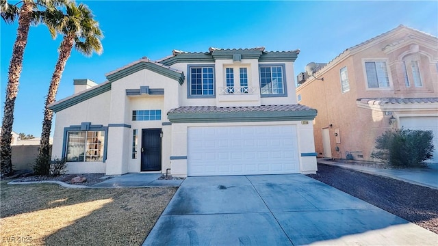 mediterranean / spanish-style home featuring driveway, an attached garage, and stucco siding