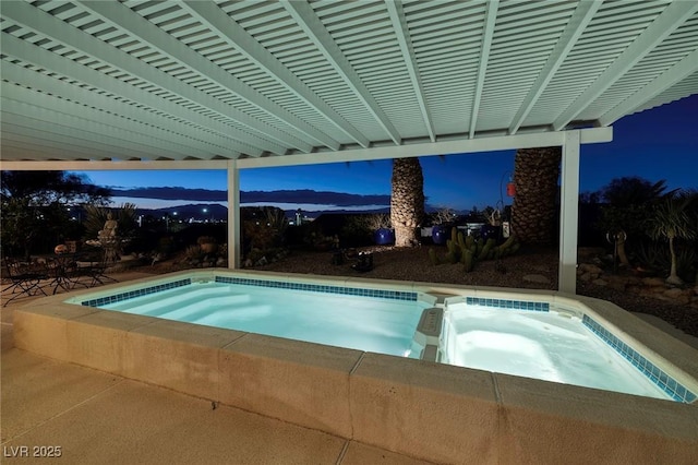 view of swimming pool featuring a pool with connected hot tub