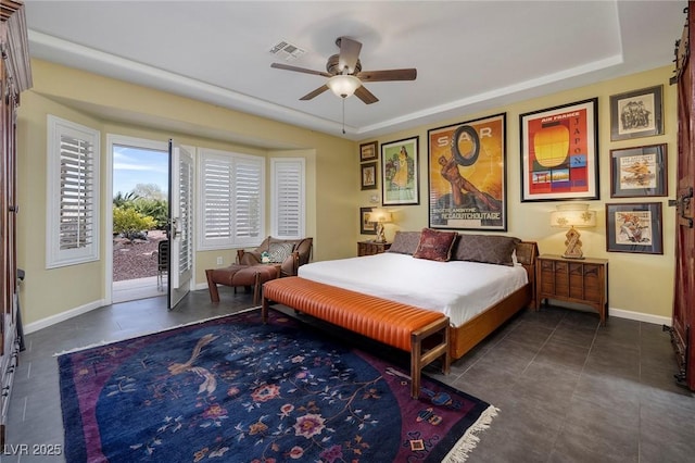 bedroom featuring visible vents, baseboards, a ceiling fan, dark tile patterned flooring, and access to outside